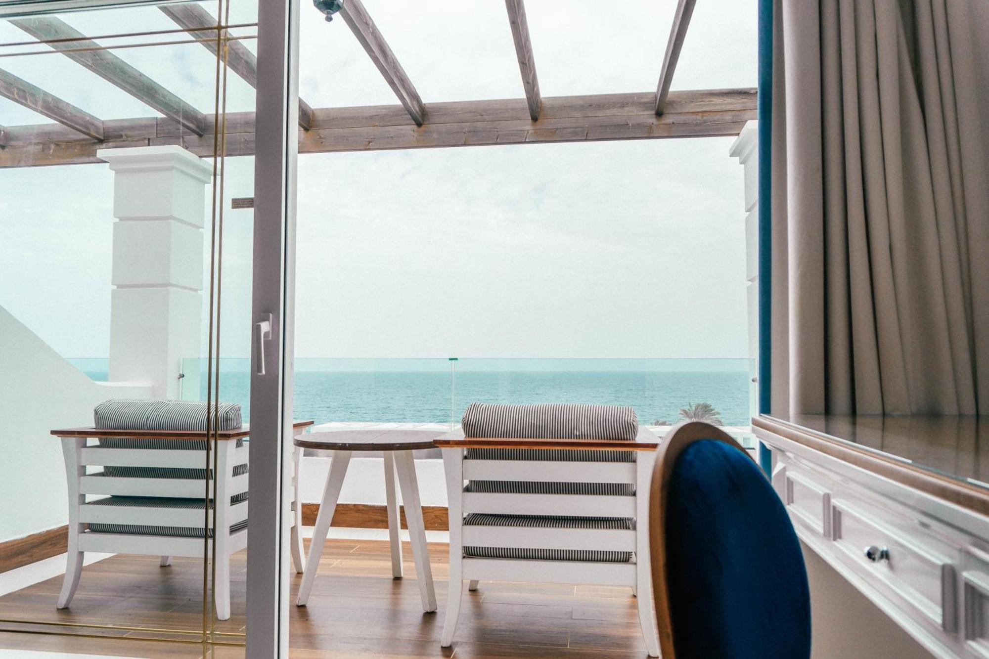 Minos Imperial Luxury Beach Resort & Spa Milatos Esterno foto A view from the balcony of a suite on board the World Voyager